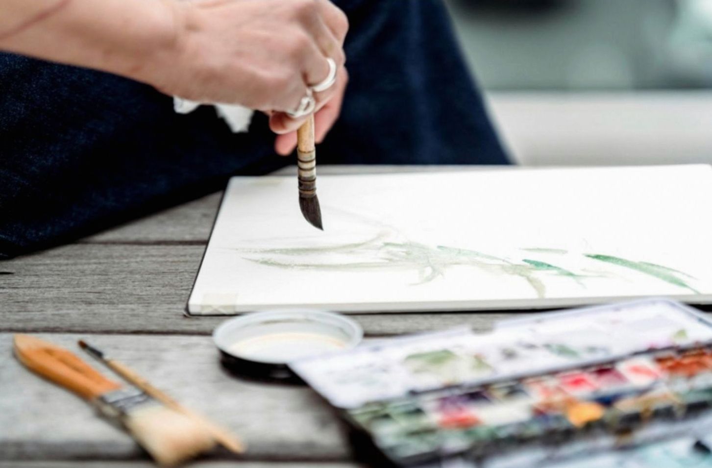 Sketching workspace with tools and materials arranged on a wooden surface